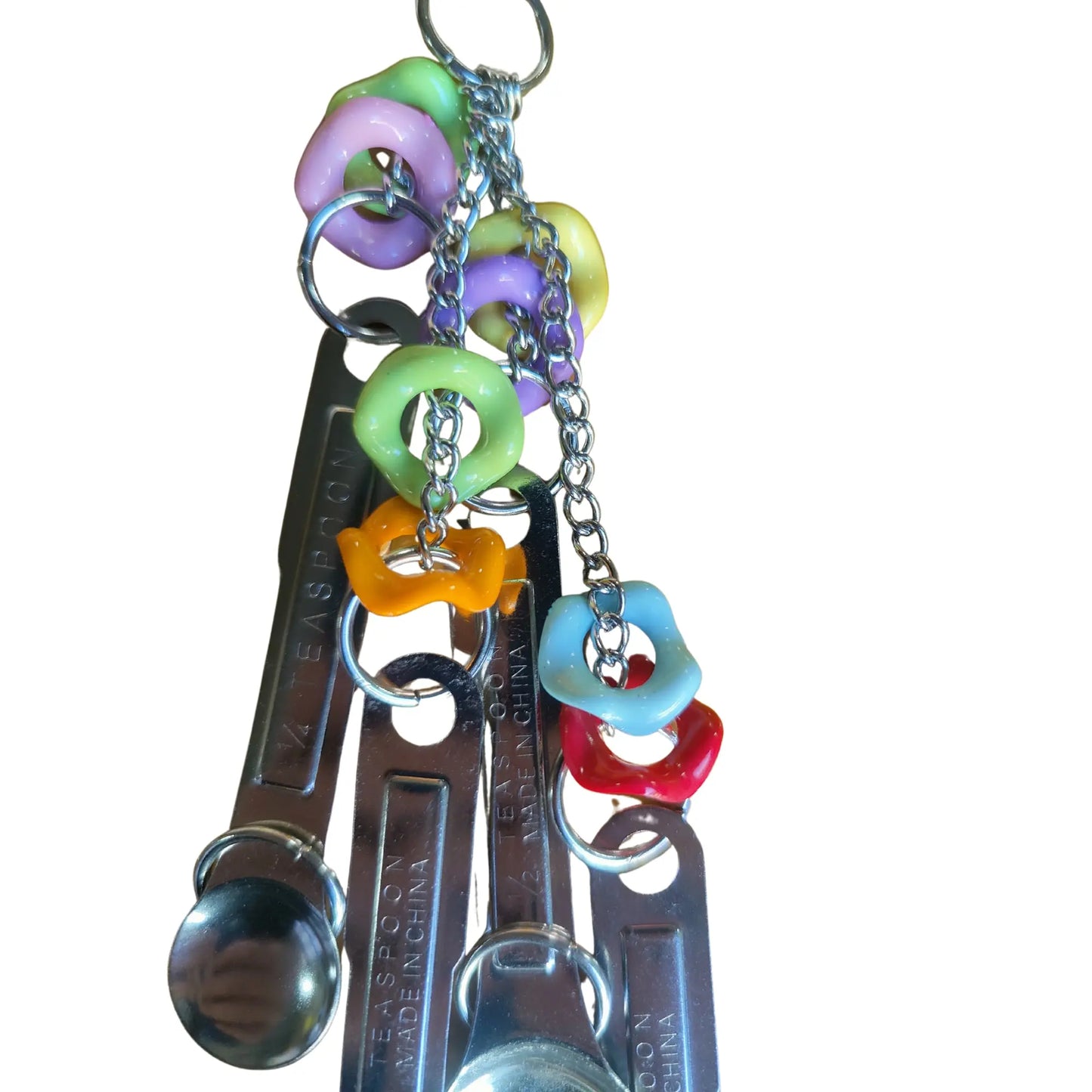 close up wiggle rings and stainless steel spoons bird toy