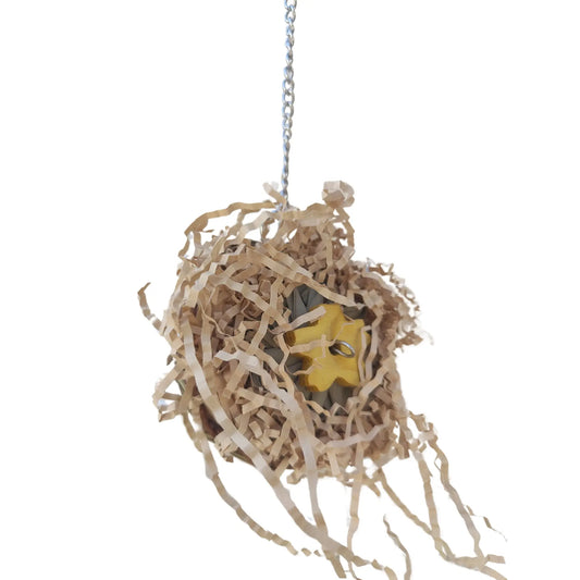 cane nest on side filled with shred paper bird toy