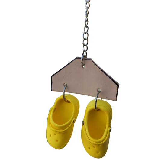 two crocs on a piece of leather bird toy