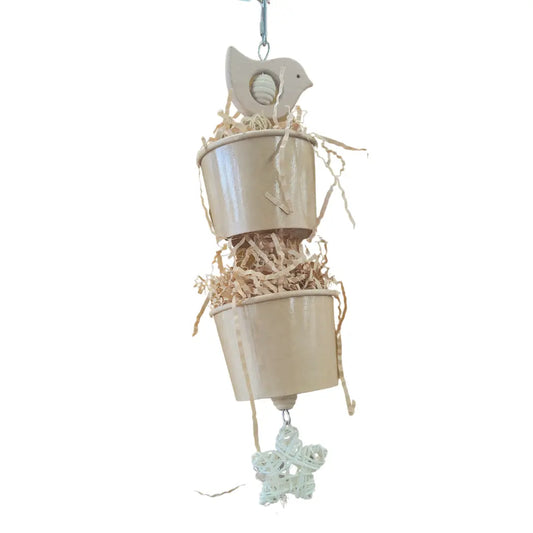 two cups filled with shredded paper with a cute bird on top bird toy