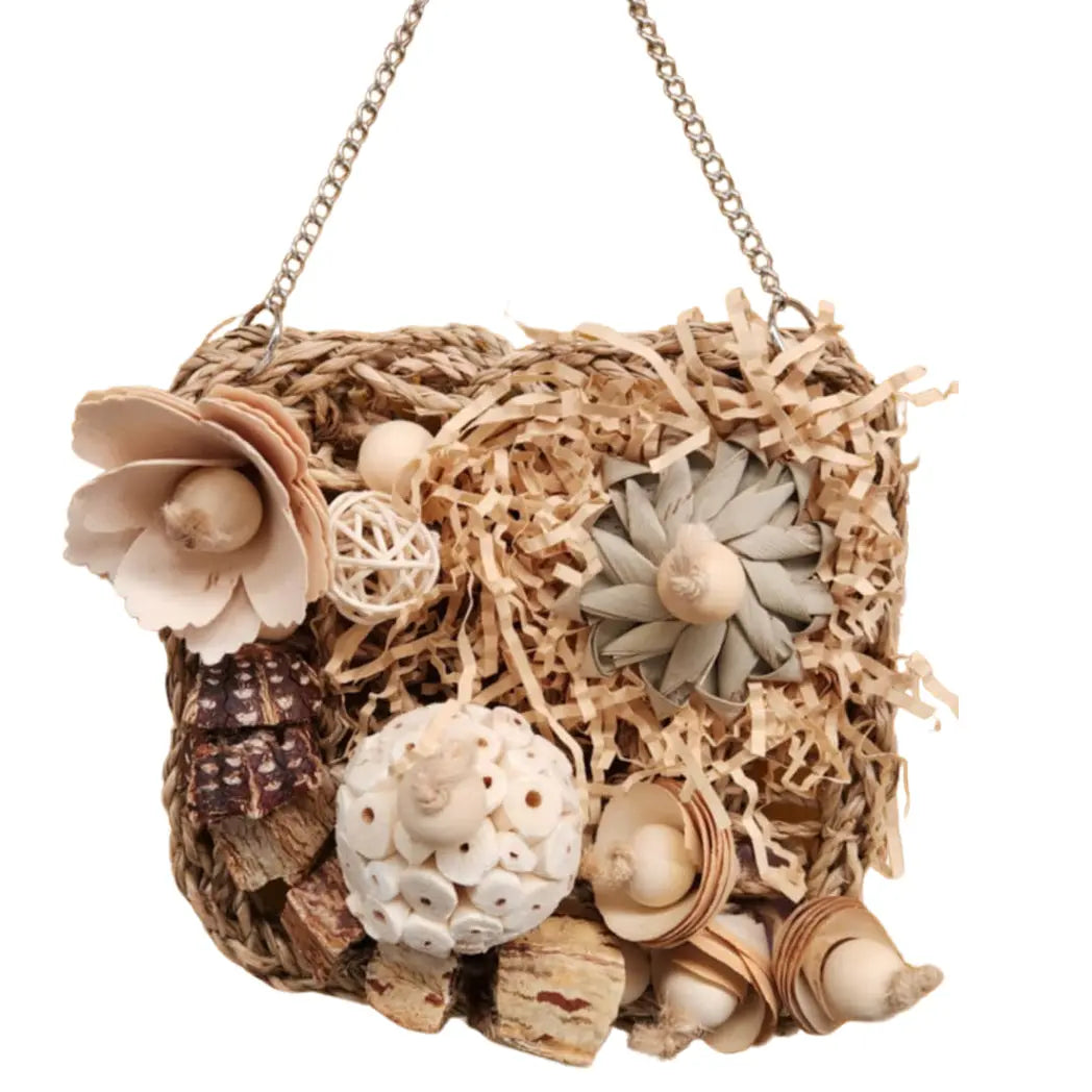 natural mat bird toy with natural pieces to chew on it, all hanging from a metal chain