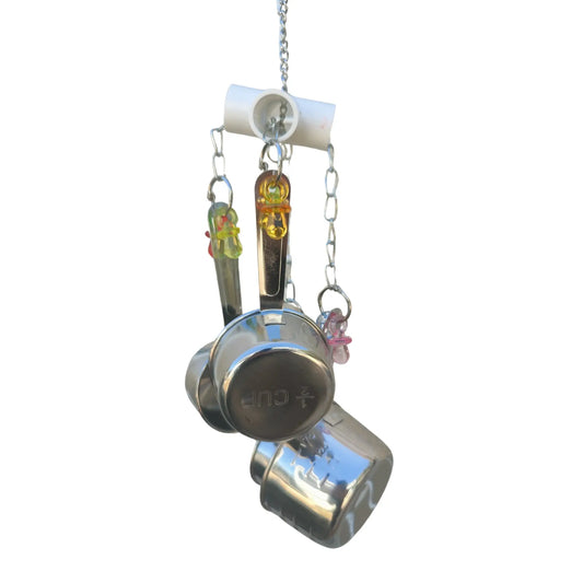 measuring cups hanging from a 4 way pvc piece