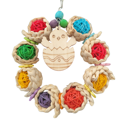 ring of coloured cane balls with a wooden chick in the center bird toy