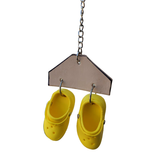 two crocs on a piece of leather bird toy