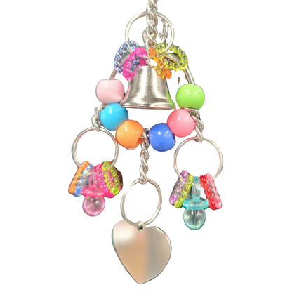 close up of the hanging metal heart bird toy by lou lou bells bird toys
