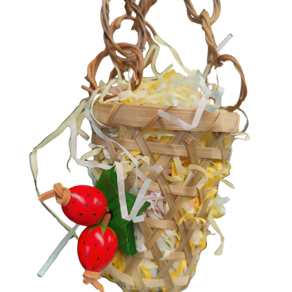 close up of the cane haning basket with strawberry bird toy