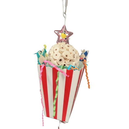 Red and white box with paper, finger traps and a sola ball in it. All hanging from a wire with a quick link at the top to connect to your bird cage. Your medium size birds will have fun foraging and chewing this shredable bird toy.