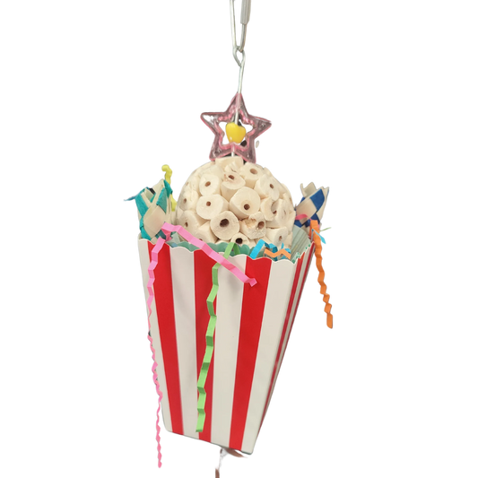 Red and white box with paper, finger traps and a sola ball in it. All hanging from a wire with a quick link at the top to connect to your bird cage. Your medium size birds will have fun foraging and chewing this shredable bird toy.