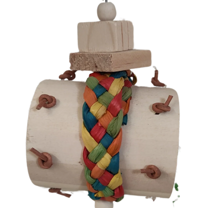 Closeup Wood barrel, coloured palm leaf weave strap, wood blocks, metal chain all joined together with a bell on the bottom. Natural tough but wreckable. Suitable for medium size birds.